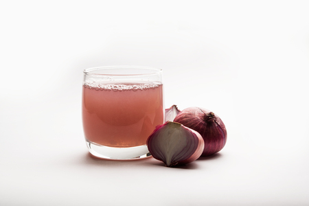 Medicinal Onion juice/syrup in a glass with raw onions. selective focusの写真素材