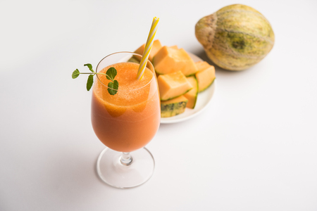 Musk melon juice with slice, also known as Kharbuj/kharbuja fruit extract, served in a glass with mint. selective focusの写真素材