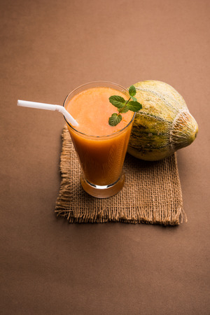 Musk melon juice with slice, also known as Kharbuj/kharbuja fruit extract, served in a glass with mint. selective focusの写真素材