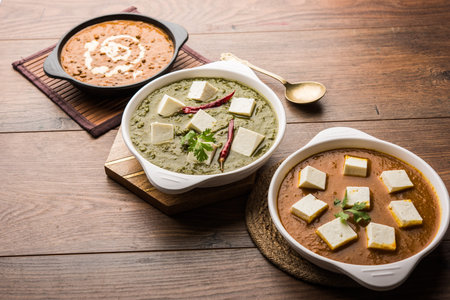 Palak paneer butter masala, yellow dal or dal-makhani served in a bowl in a group. selective focus