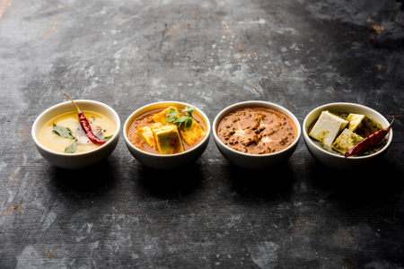 Palak paneer butter masala, yellow dal or dal-makhani served in a bowl in a group. selective focusの写真素材