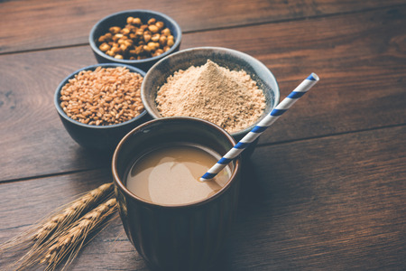 Sattu sharbat is a cooling sweet drink made in summer with roasted black chickpea flour, barley, suger, salt & water. served in a glass. selective focusの写真素材