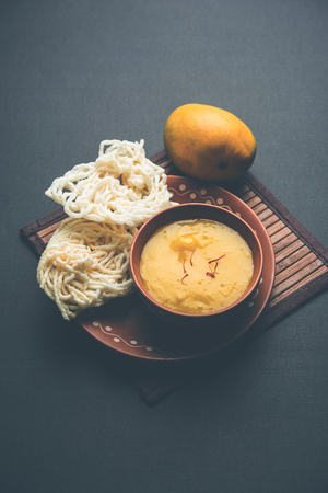 Aam Ras or Alphonso mango pulp with kurdai which is a fried dish made using wheat/gehu. selective focusの写真素材