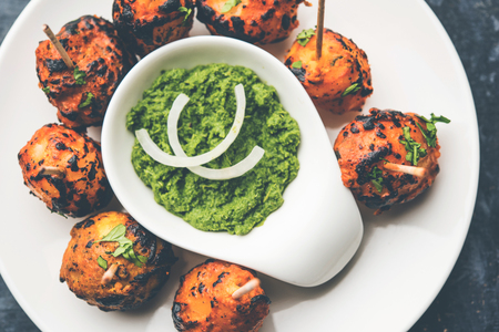 Tandoori aloo are roasted potatoes with Indian spices. It's a party appetizer served with green chutney.の写真素材