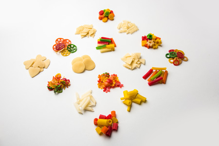 Snack pellets are non-expanded products made with raw materials like cereals, potatoes or vegetable powders, later processed using frying, hot air baking. multicoloured / shaped ready-to-eat snacksの写真素材