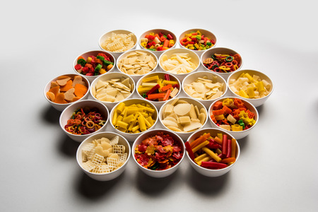 Snack pellets are non-expanded products made with raw materials like cereals, potatoes or vegetable powders, later processed using frying, hot air baking. multicoloured / shaped ready-to-eat snacksの写真素材