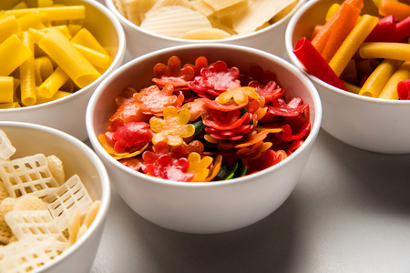 Snack pellets are non-expanded products made with raw materials like cereals, potatoes or vegetable powders, later processed using frying, hot air baking. multicoloured / shaped ready-to-eat snacksの写真素材
