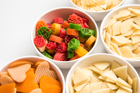 Snack pellets are non-expanded products made with raw materials like cereals, potatoes or vegetable powders, later processed using frying, hot air baking. multicoloured / shaped ready-to-eat snacksの写真素材