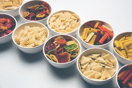 Snack pellets are non-expanded products made with raw materials like cereals, potatoes or vegetable powders, later processed using frying, hot air baking. multi colored / shaped ready-to-eat snacksの写真素材