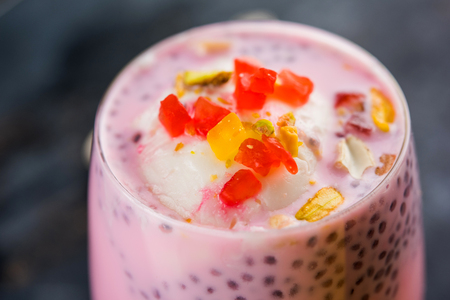 Falooda / Faluda is a popular Indian dessert - Strawberry and Mango flavoured which has Ice cream, noodles, sweet basil seeds and nuts, selective focusの写真素材