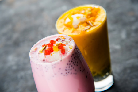 Falooda / Faluda is a popular Indian dessert - Strawberry and Mango flavoured which has Ice cream, noodles, sweet basil seeds and nuts, selective focusの写真素材