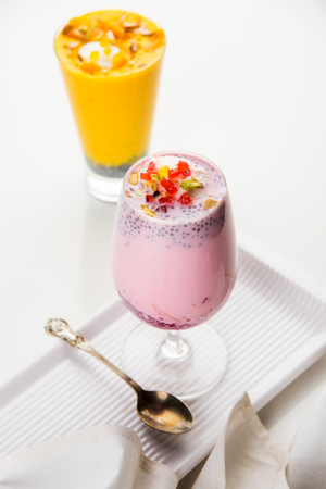 Falooda / Faluda is a popular Indian dessert - Strawberry and Mango flavoured which has Ice cream, noodles, sweet basil seeds and nuts, selective focusの写真素材