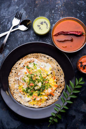 Egg Dosa is a popular south indian non-vegetarian breakfast or meal, served with sambar and chutneyの写真素材