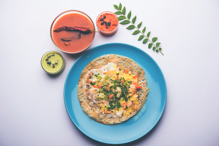 Egg Dosa is a popular south indian non-vegetarian breakfast or meal, served with sambar and chutneyの写真素材