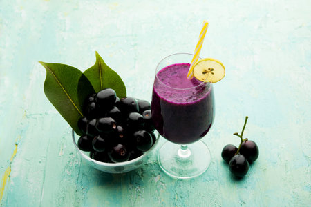 Juice of jamun fruit in a glass also called as java plum, jambolan plum, jambhul, syzygium cumini