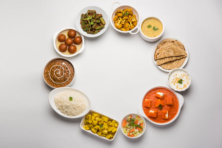 Assorted Indian food like paneer butter masala, dal, roti, rice, sabji, gulab jamun and bound raita...