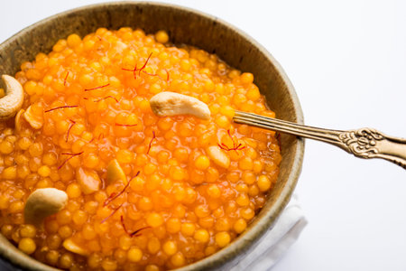 Sabudana or Sago Kesari dessert for Vrat Upvas also known as Sweetened Tapioca Pearl. served in a...