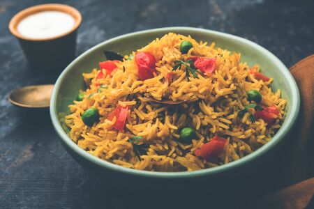 Tomato Pulav or Pilaf made using basmati rice and red tomatoes, served in a bowl. selective focusの写真素材