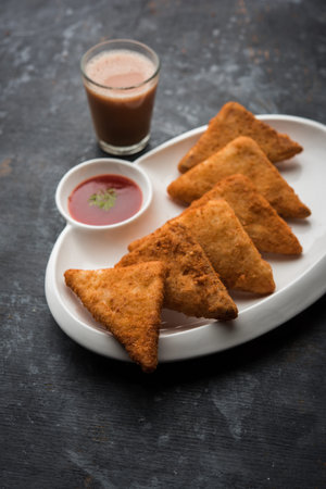 crispy Potato triangles or batata vada covered with bread crumbs and then deep fried. served with...