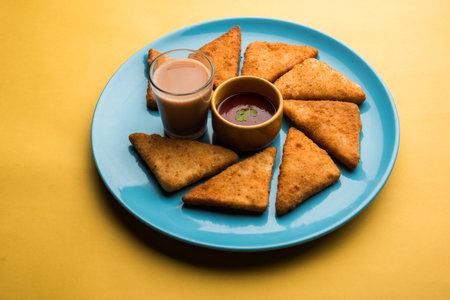 crispy Potato triangles or batata vada covered with bread crumbs and then deep fried. served with...