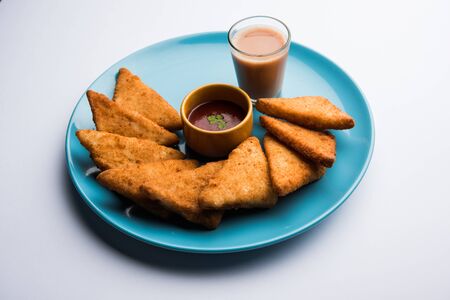 crispy Potato triangles or batata vada covered with bread crumbs and then deep fried. served with tomato ketchup. selective focusの写真素材