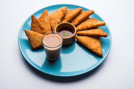 crispy Potato triangles or batata vada covered with bread crumbs and then deep fried. served with tomato ketchup. selective focusの写真素材