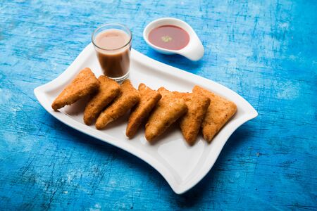 crispy Potato triangles or batata vada covered with bread crumbs and then deep fried. served with tomato ketchup. selective focusの写真素材