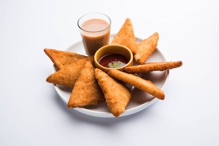 crispy Potato triangles or batata vada covered with bread crumbs and then deep fried. served with tomato ketchup. selective focusの写真素材