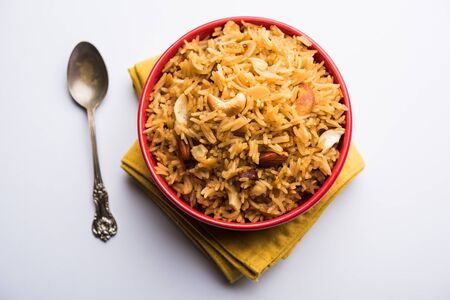 Traditional Jaggery Rice or Gur wale chawal in Hindi, served in a bowl with spoon. selective focusの写真素材