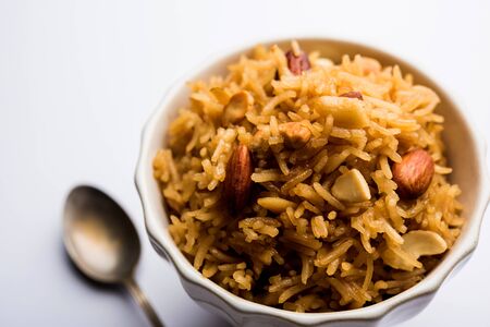 Traditional Jaggery Rice or Gur wale chawal in Hindi, served in a bowl with spoon. selective focusの写真素材