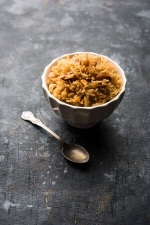 Traditional Jaggery Rice or Gur wale chawal in Hindi, served in a bowl with spoon. selective focusの写真素材