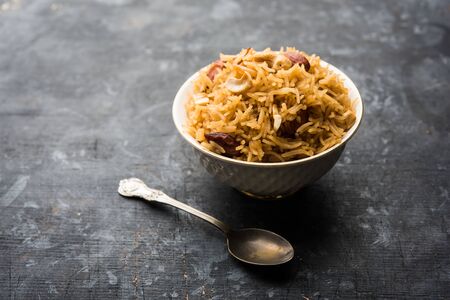 Traditional Jaggery Rice or Gur wale chawal in Hindi, served in a bowl with spoon. selective focusの写真素材