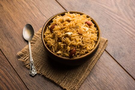 Traditional Jaggery Rice or Gur wale chawal in Hindi, served in a bowl with spoon. selective focusの写真素材