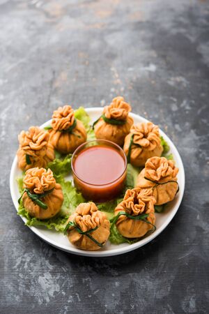 Crispy Potli Samosa or veg money bags are delicious Indian snacks of spiced aloo and mix veggies Or Meat/kheema  stuffed in flaky dough. It's a great creative starter or appetiser. served with ketchupの写真素材