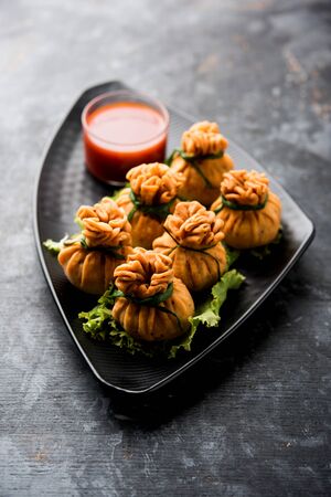 Crispy Potli Samosa or veg money bags are delicious Indian snacks of spiced aloo and mix veggies Or Meat/kheema  stuffed in flaky dough. It's a great creative starter or appetiser. served with ketchupの写真素材