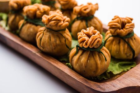 Crispy Potli Samosa or veg money bags are delicious Indian snacks of spiced aloo and mix veggies Or Meat/kheema  stuffed in flaky dough. It's a great creative starter or appetiser. served with ketchupの写真素材