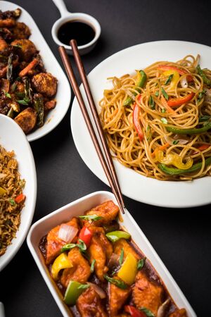Assorted Indo chinese dishes in group includes Schezwan/Szechuan hakka noodles, veg fried rice, veg manchurian, american chop suey, chilli paneer, crispy vegetable and vegetable soupの写真素材