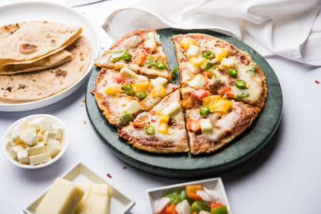 Chapati Pizza made using leftover Roti / Paratha with Cheese, vegetables, paneer and Sausageの写真素材