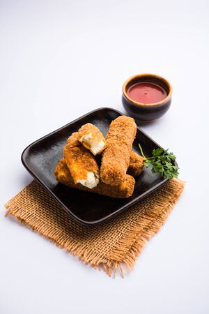 Kurkuri paneer fingers or pakora/pakoda snacks also known as Crispy Cottage Cheese Bars, served with tomato ketchup as a starter. selective focusの写真素材