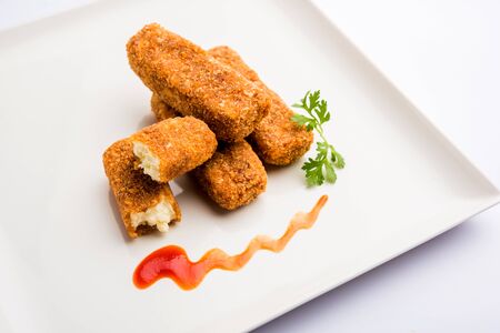 Kurkuri paneer fingers or pakora/pakoda snacks also known as Crispy Cottage Cheese Bars, served with tomato ketchup as a starter. selective focusの写真素材