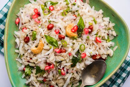 Dapde Pohe is a typical Maharashtrian breakfast, made with thin variety of poha and fresh coconut with chili, peanuts and nuts. served in a bowl or plate.の写真素材