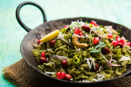 Hariyali Poha / Green Masala Pohe or flattened rice served in a bowl, selective focus