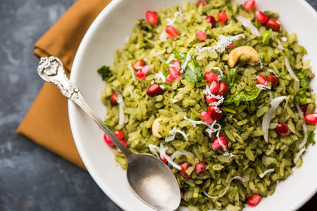 Hariyali Poha / Green Masala Pohe or flattened rice served in a bowl, selective focus
