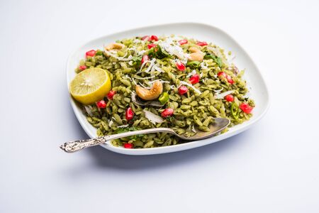 Hariyali Poha / Green Masala Pohe or flattened rice served in a bowl, selective focusの写真素材