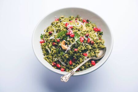 Hariyali Poha / Green Masala Pohe or flattened rice served in a bowl, selective focusの写真素材