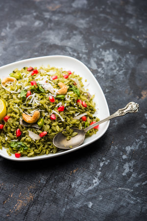 Hariyali Poha / Green Masala Pohe or flattened rice served in a bowl, selective focus