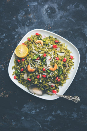 Hariyali Poha / Green Masala Pohe or flattened rice served in a bowl, selective focus