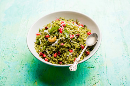 Hariyali Poha / Green Masala Pohe or flattened rice served in a bowl, selective focus