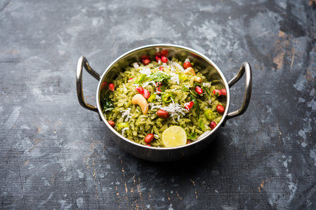 Hariyali Poha / Green Masala Pohe or flattened rice served in a bowl, selective focus