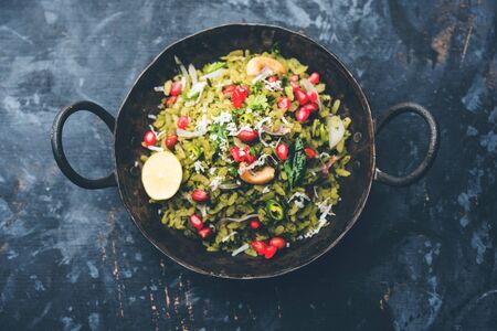 Hariyali Poha / Green Masala Pohe or flattened rice served in a bowl, selective focusの写真素材